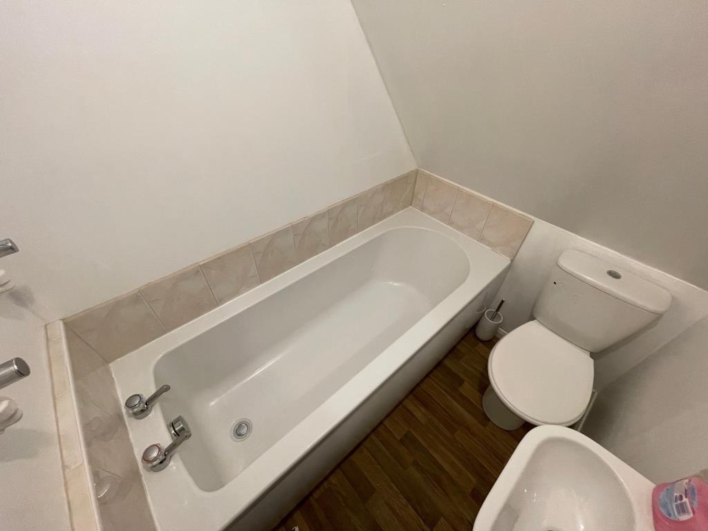 Lot: 101 - DETACHED BUILDING WITH POTENTIAL - Bathroom with white suite including bath wash hand basin and toilet